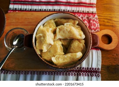 Dumplings With Fish In A Pot On A Wooden Table. Ukrainian Cuisine