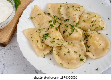 Dumplings with potatoes with green dill. Varenyky, vareniki, pierogi, pyrohy.