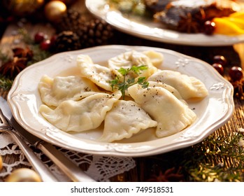 Dumplings Stuffed With Mushroom And Cabbage On A White Plate On Wooden Table.Traditional Christmas Eve Dish In Poland