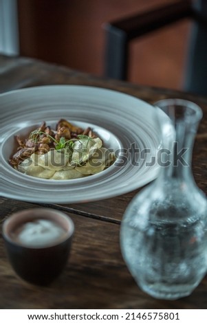 Dumplings, Vodka, Vareniki on White plate, Traditional Ukrainian food, Restaurant food