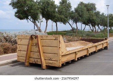 Dumpster Waste Metal Tank Container Filled With Ground, Rubble Near A Construction Site.