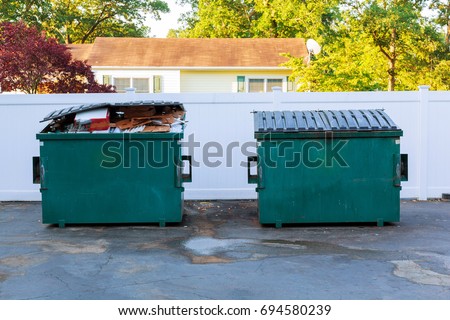 Dumpsters being full with garbage container Over flowing