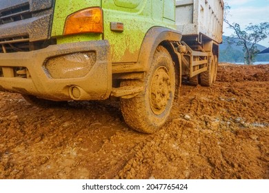 Dumptruck With Muddy Front Wheels.