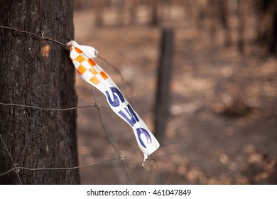 Dunalley, Australia-February 3, 2013. State Emergency Services Tape Attached To A Rural Fence Where A Bushfire Has Destroyed Homes, Dunalley, Tasmania, Australia