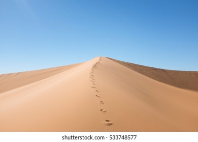 Dune With Footsteps In The Desert