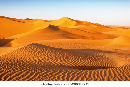 A dune landscape in the Rub al Khali or Empty Quarter. Straddling Oman, Saudi Arabia, the UAE and Yemen, this is the largest sand desert in the world. - Shutterstock ID 2090383921