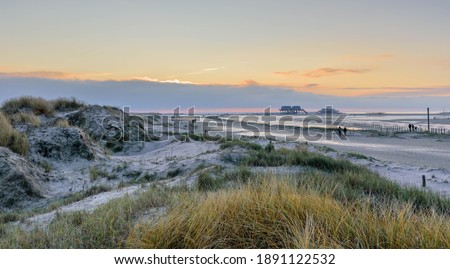 Dune landscape view of a beach and stilt houses, St Peter-Ording, North Friesland, Germany, Europe.