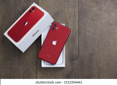 Dunedin, Florida / US .- September 23 2019: New iPhone 11 product red model smartphone developed by apple top down view with box half open