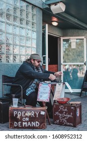 Dunedin, Florida/USA January 05, 2020: A Bearded Man Writing Poetry On A Type Writer At An Art Festival In Downtown Dunedin