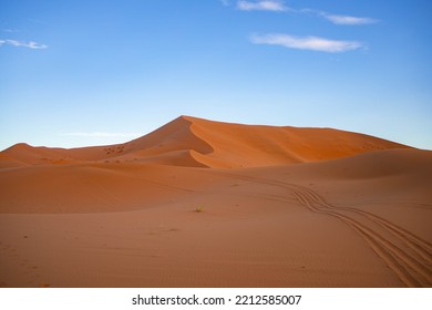 Dunes lit by sunrise in Merzouga desert, Morocco.