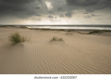 Dunes under a cloudy dramatic sky 