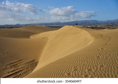 Dunes with wavy forms in desert under blue sky / Large sandy dunes in a wide desert next to the southbeach of Gran Canaria lookalike Sahara / Very dry and sandy desert in South-beach of Gran Canaria