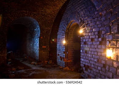 Dungeon Under The Old German Fortress Illuminated By Lantern And Candles