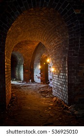 Dungeon Under The Old German Fortress Illuminated By Lantern And Candles