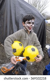 Dunkerque, France-23 January 2016:Boy Is Very Happy With Football Given By Volunteers At The Refugee Camp Grande-Synthe In France Is A Muddy Camp With A Lot Of Dirty Waste. People Are Cold And Hungry.