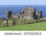 Dunluce Castle on Irish Sea and Atlantic Ocean County Antrim Northern Ireland with blue sea background 