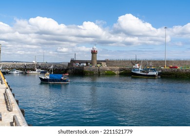 Dunmore East, Ireland - 17 August, 2022: Small Fishing Trawler Leaving Dunmore East Harbor And Heading Out To The Irish Sea