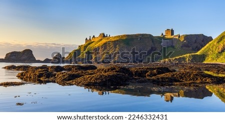 Dunnottar Castle bathed in morning sunlight, taken from Castle Haven near Stonehaven in Aberdeenshire.