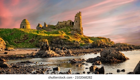 The Dunure Castle surrounded by the sea during the sunrise in Scotland