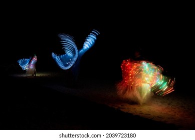 A Duo Baton Show Made Of Colorful LED Lights With Beautiful Patterns That Change As The Lights Twirling.