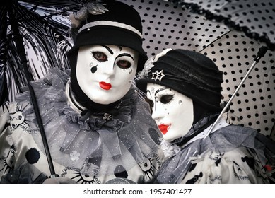 Duo of characters of a carnival in Pierrot costume (character of pantomime and commedia dell'arte)