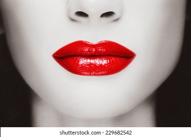 Duotone close-up shot of woman lips with glossy red lipstick