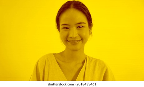 Duotone Or Half Tone Portrait Of Young Asian Woman In Studio Looking At Camera