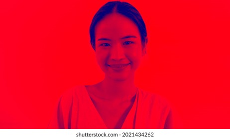 Duotone Or Half Tone Portrait Of Young Asian Woman In Studio Looking At Camera