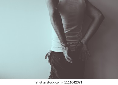 Duotone Image Of Gang Member Under Arrest With Handcuffs Put Against The Wall, Conceptual Image