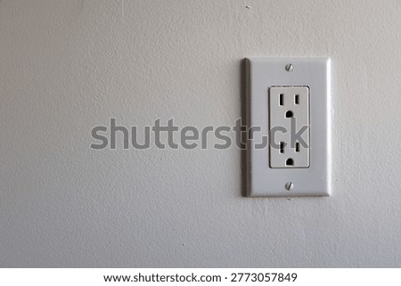 Duplex Electrical Outlet Close Up on White Wall Residential Utility Background