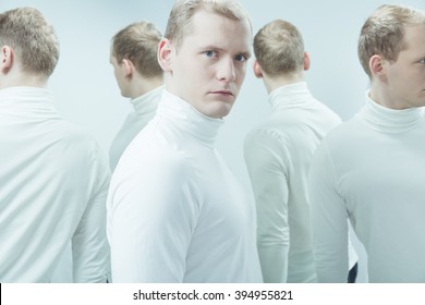 Duplicated image of man with mental problem, standing in white interior