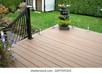 Durable deck solution with composite boards and glass panels as railings on residential home improvement project.