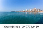 Durban beachfront clear blue ocean sea waters along beach coastline with public piers jetty