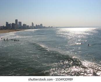 Durban Beachfront And Surfers From A Pier.