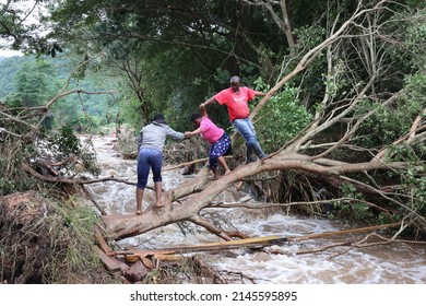 Durban, KwaZulu Natal - 04 13 2022: People crossing a flood river in Durban floods