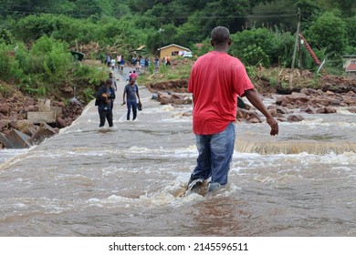 Durban, KwaZulu Natal - 04 13 2022: people crossing a flooded bridge 