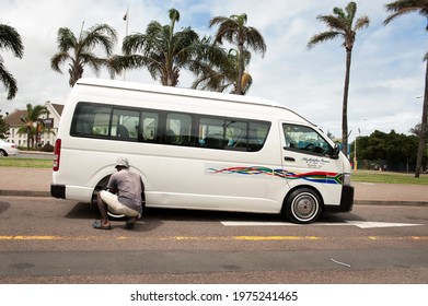 Durban KZN, South Africa - November 27th, 2015:  A Taxi Driver Works On His Minibus Taxi In The Warwick Triangle Taxi Stand In Durban South Africa