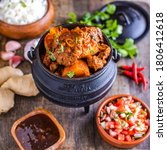 Durban Lamb Curry in potjie pot surrounded by ingredients