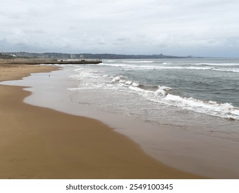 Durban sandy beach, stormy indian ocean, South Africa. Beachfront high rise buildings and cloudy sky - Powered by Shutterstock