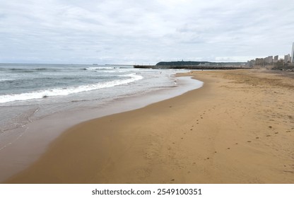 Durban sandy beach, stormy indian ocean, South Africa. Beachfront high rise buildings and cloudy sky - Powered by Shutterstock