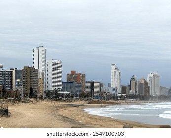 Durban sandy beach, stormy indian ocean, South Africa. Beachfront high rise buildings and cloudy sky - Powered by Shutterstock