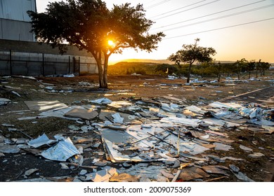 Durban, South Africa, 14 July 2021. Litter lies scattered around outside of a looted warehouse, after protestors passed through the industrial area north of the city.