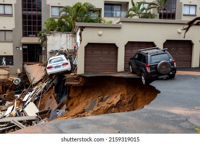 Durban, South Africa, 22 May 2022. Two damaged cars that were abandoned when flooding caused a large landslide and destruction to occur.