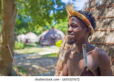 
DURBAN- SOUTH AFRICA- JANUARY 15, 2020: Zulus continue their traditions in the Cultural Zulu villages in Kwazulu Natal. A Zulu warrior appears in the photo.