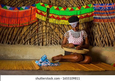 
DURBAN- SOUTH AFRICA- JANUARY 15, 2020: Zulu Girls Make Jewelry With Handcrafted Beads In The Cultural Zulu Villages In Kwazulu Natal.