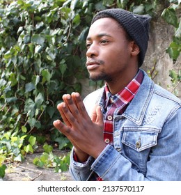 Durban, South Africa- September 21 2019 : Black Boy Praying Outside On A Winter Day.