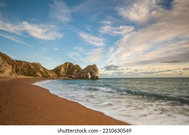 Durdle Door. Famous Coastal Geological Feature On England's Jurassic Coast, In Dorset.  It Is A Sunny Day.