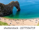 Durdle Door natural arch with its bay and beach. Clear sea water near Lulworth, Jurassic Coast, Dorset, south of England.