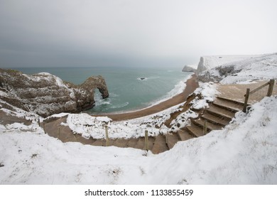 Durdle Door In The Snow On The Dorset Coast.