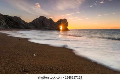 Durdle Door Sunrise Through The Arch 